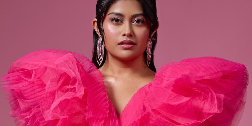 Ashley R. Singh in a bold pink gown, feature debut in Doin’ It, Ebby Magazine profile on fearless comedy and South Asian representation.