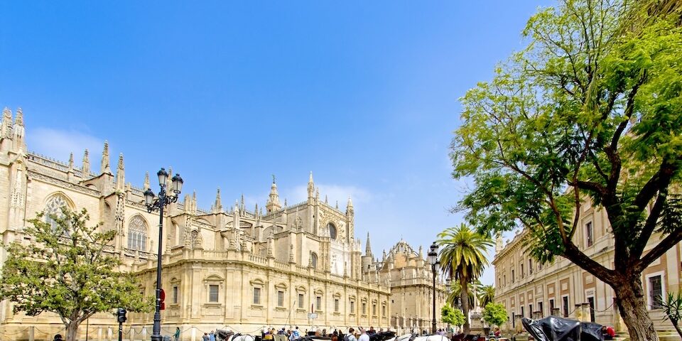 Elegant horse-drawn carriages in front of Seville Cathedral, Andalusia, Spain