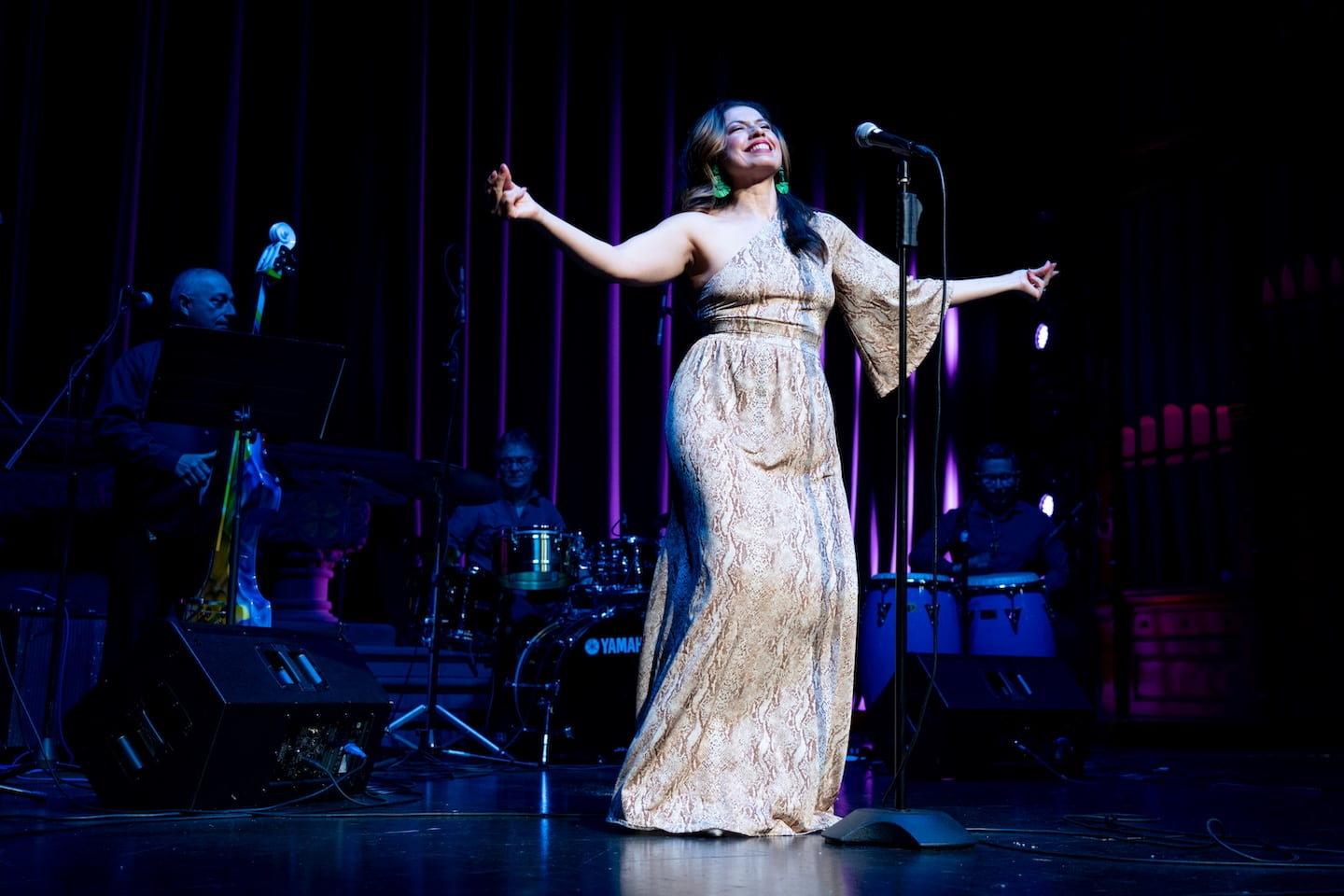 Sandra Delgado performing on stage as a singer with live band