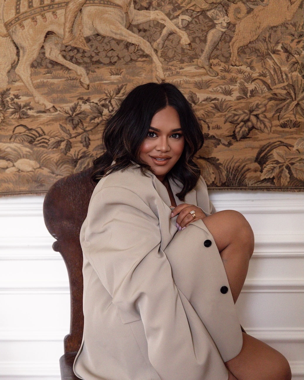 Nabela Noor seated portrait wearing a neutral blazer, founder of Nabela Noor Home known for her modern approach to homemaking and intentional living