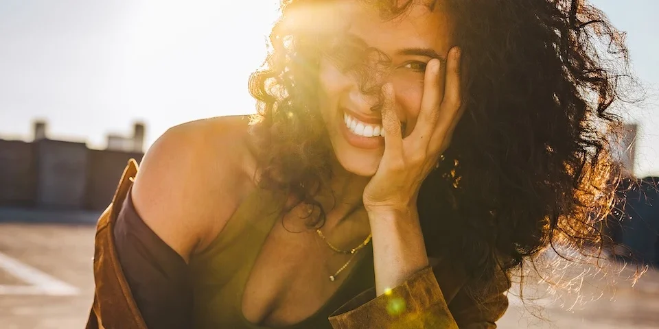Alexandra Metz The Pitt actress smiling portrait natural curls golden sunlight warm light face