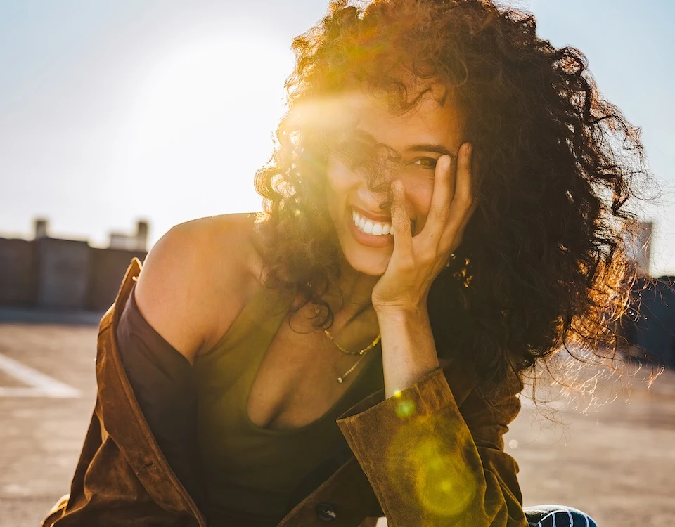 Alexandra Metz The Pitt actress smiling portrait natural curls golden sunlight warm light face