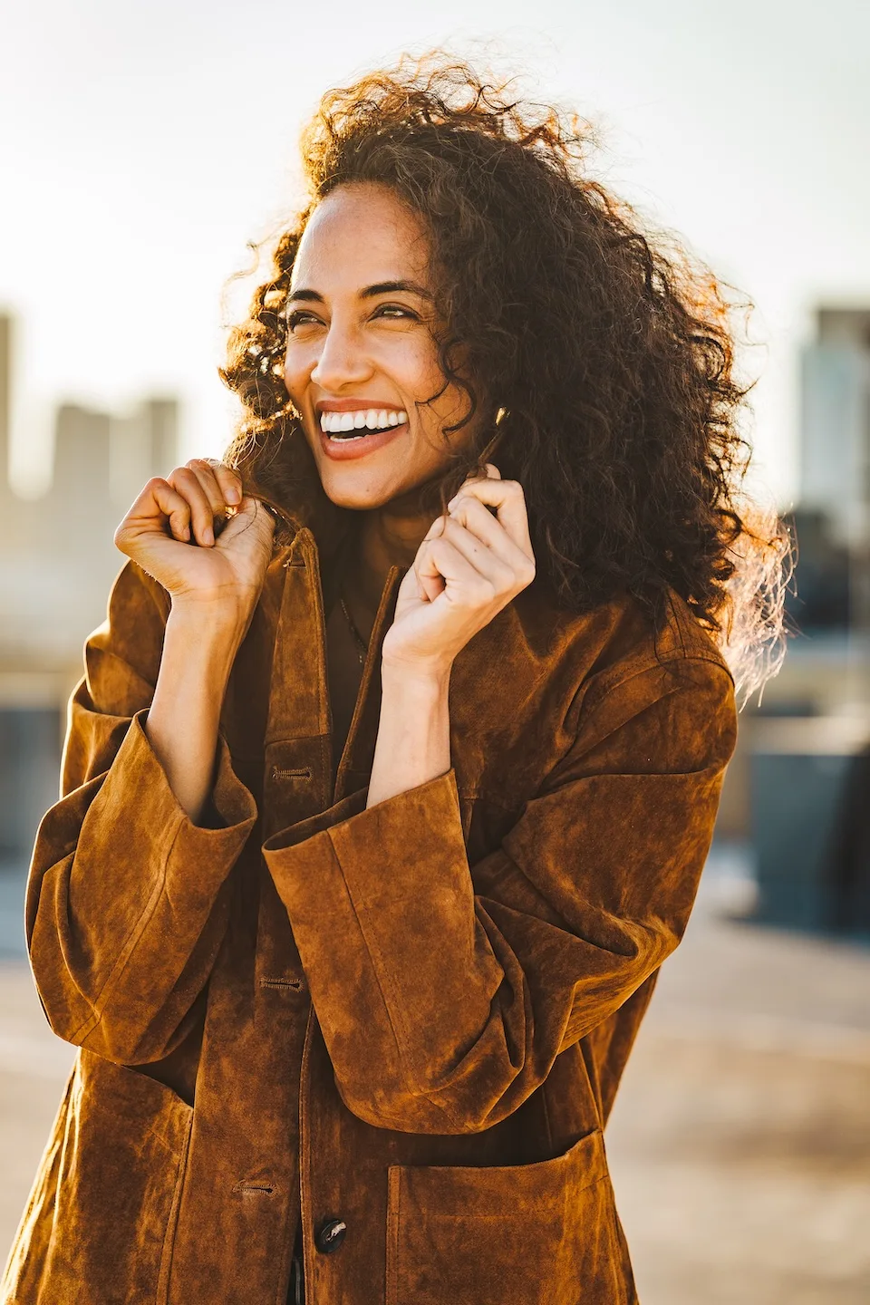 Alexandra Metz The Pitt actress smiling portrait natural curls warm sunlight outdoor