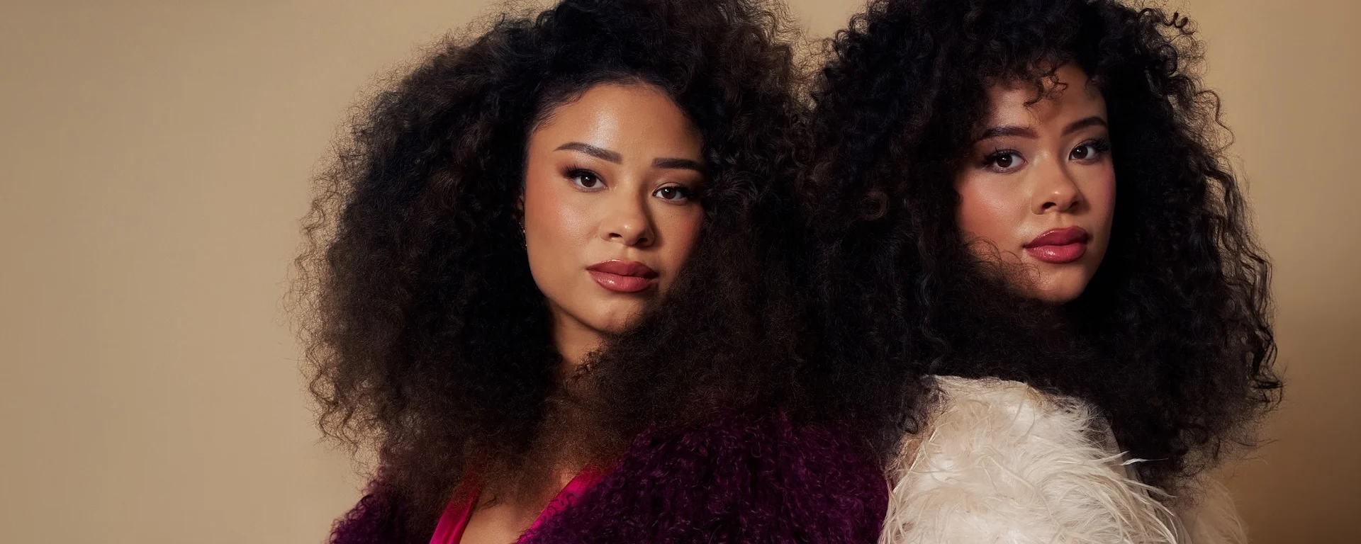 Ana and Lexie Learmann Twins in pink studio portrait for Ebby Magazine feature on beauty and well-being