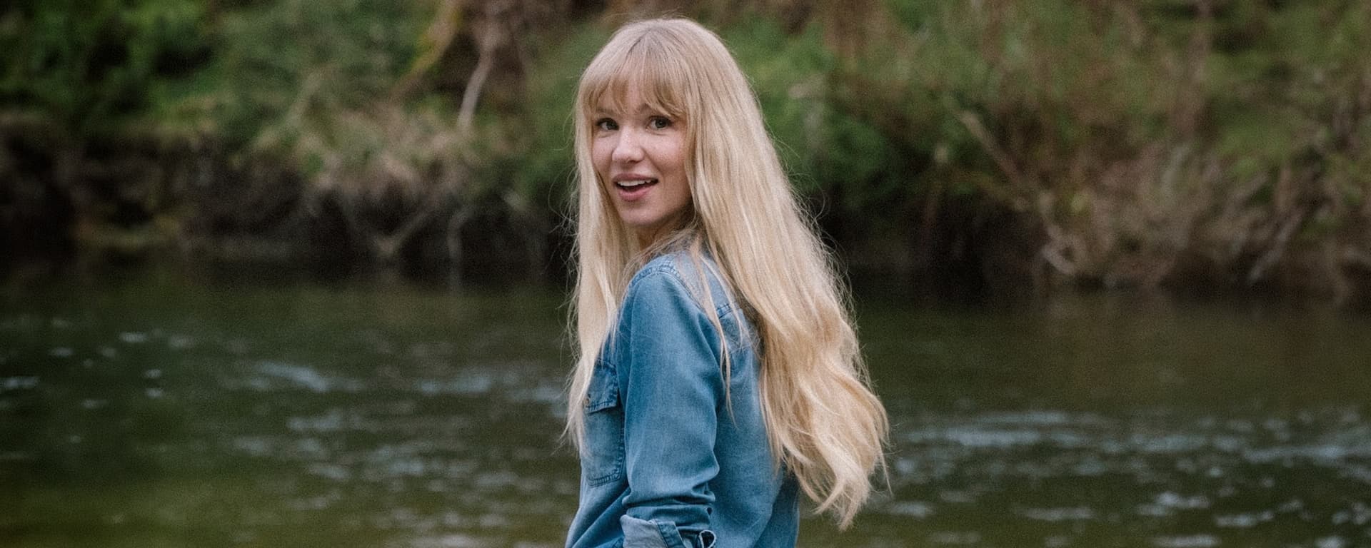 Debs Howard portrait by water for Die My Love interview Ebby Magazine