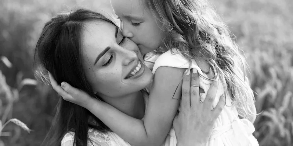 mother and daughter embracing black and white luxury mother’s day gifts