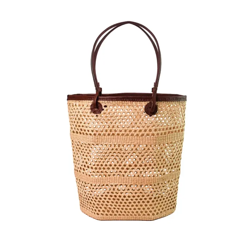 Open weave straw tote bag with cognac leather handles featured as an Ebby Magazine Editors Pick